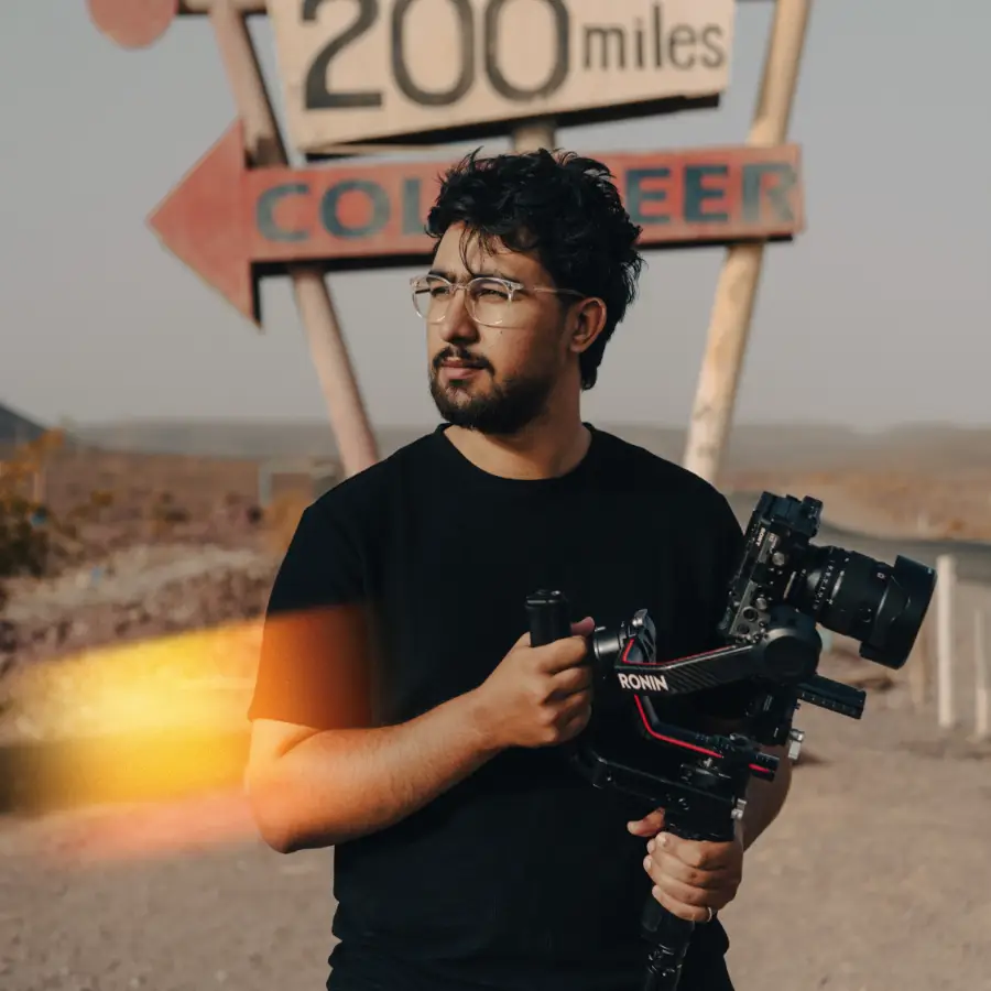 Ayoub Ouazzou holding a camera on a gimbal in the desert